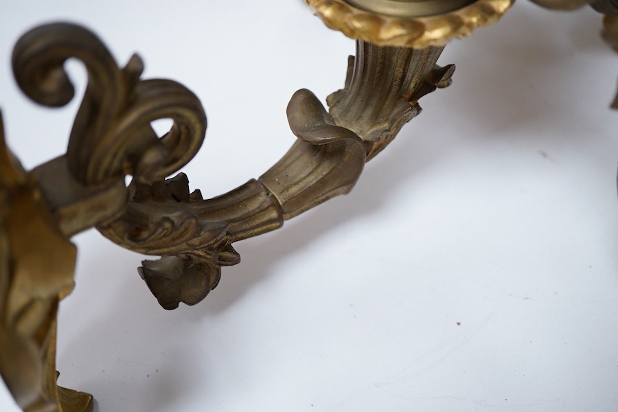 A pair of cast brass three branch wall sconces, 27cm deep